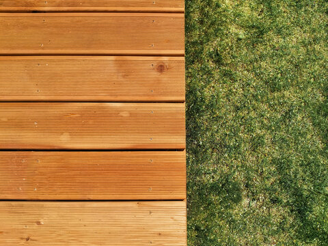decking wooden board ang grass close up texture flat lay