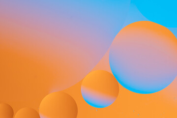 Abstract image with smooth transitions of orange and blue colors, creating vibrant and dynamic fluid pattern.