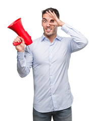 Handsome young man holding microphone with happy face smiling doing ok sign with hand on eye looking through fingers