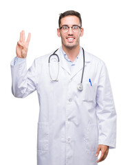 Fototapeta premium Handsome young doctor man showing and pointing up with fingers number three while smiling confident and happy.