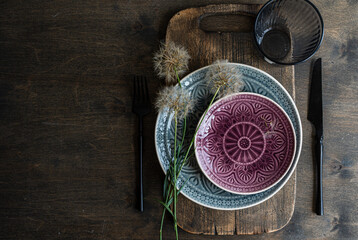 Rustic dining setting with dandelion and patterned ceramics