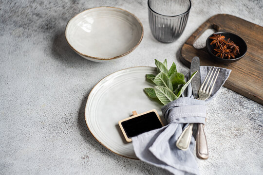 Minimalistic summer table setting with fresh mint accents