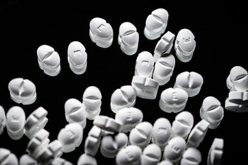 Narcotic substances, antidepressant, dope powder, syringes with drugs dose, white pills on dark...
