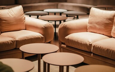 Obraz premium Corner of cozy living room or coworking space with two comfortable couches of delicate color standing in front of group of round tables