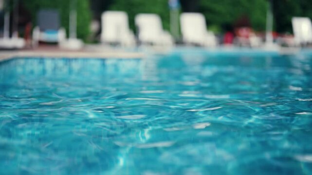 Luxurious resort swimming pool with a backdrop of lounge chairs, ideal for relaxation and leisure during a vacation.