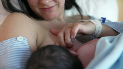 Intimate Post-Delivery Bonding - New Mother Feeds Newborn in Hospital, Highlighting First Moments...