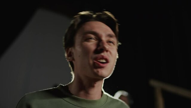 Young actor performing dramatic monologue on theatre stage while having rehearsal or audition