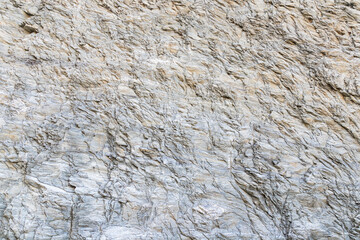 Natural stone background with rough texture. Dark gray stone texture.  Mountain surface. Rock texture. Nature detail of rocks.