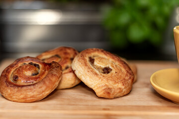 Close up of Sweet cinnamon roll with raisins filling served on the black plate, Close up of Sweet cinnamon roll cake with raisins filling, 