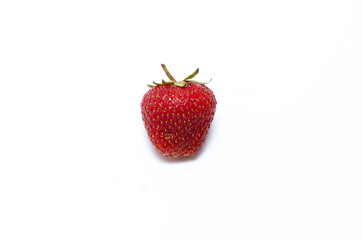 Single fresh ripe natural strawberry on a white table. Freshly picked garden strawberries. Detailed photo of strawberry on an abstract background. 