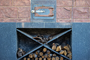 Stone stove and firewood on the shelf below it