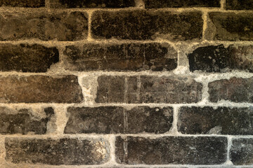 Burnt bricks of an old brick wall