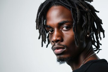 Handsome Afro American man with dreadlocks on white background.