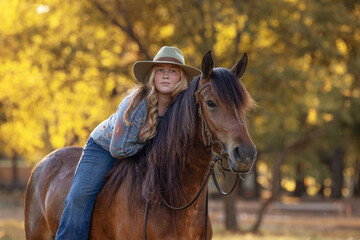 Obraz premium Girl cowgirl with horse