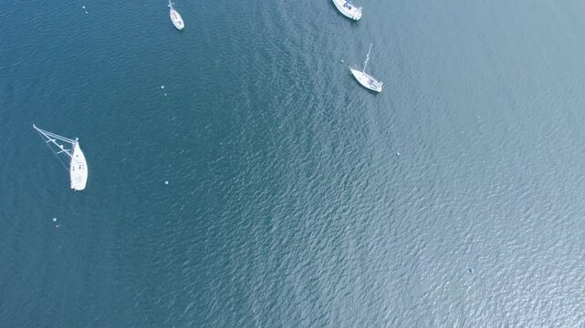 Aerial View, drone flying over a Sailboat in Scotland,  peaceful and picturesque scene.