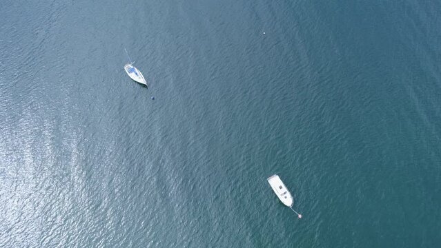 Aerial View, drone flying over a Sailboat in Scotland,  peaceful and picturesque scene.