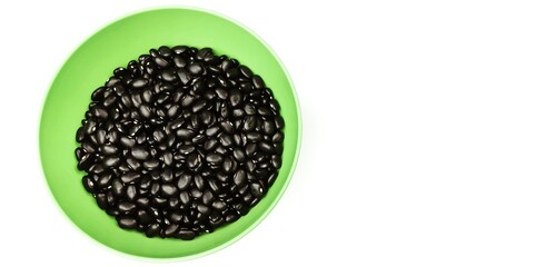 A bowl of black beans on a white background with copy space.
