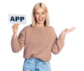 Beautiful young blonde woman holding app paper celebrating achievement with happy smile and winner expression with raised hand