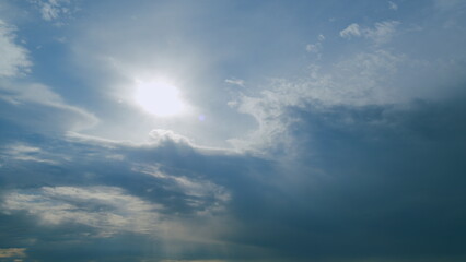 Beautiful scenic blue sky with rays of sun shining through clouds. Sun rays. Timelapse.