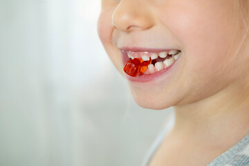 close-up preschool child, girl 5 years old wants eat gelatinous sweets, gummy bear, kid has good...