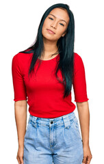 Fototapeta premium Beautiful hispanic woman wearing casual clothes relaxed with serious expression on face. simple and natural looking at the camera.