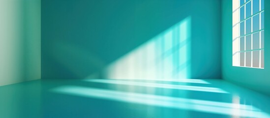 Obraz premium Empty turquoiose room with sunlight streaming through a window, casting geometric shadows. Ideal for product presentation.