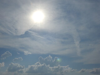 A bright sun peeking through the clouds on a hot, stormy, summer day, over Kent County, Delaware. 