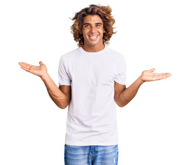 Young hispanic man wearing casual white tshirt smiling showing both hands open palms, presenting and advertising comparison and balance