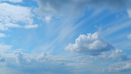 Fototapeta premium Clouds move in the blue sky. Tropical sky at day time, only white and blue colors. Semi-transparent layers on different height. Time lapse.