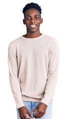Young african american man wearing casual clothes looking positive and happy standing and smiling with a confident smile showing teeth