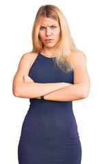 Fototapeta premium Young beautiful blonde woman wearing casual dress skeptic and nervous, disapproving expression on face with crossed arms. negative person.