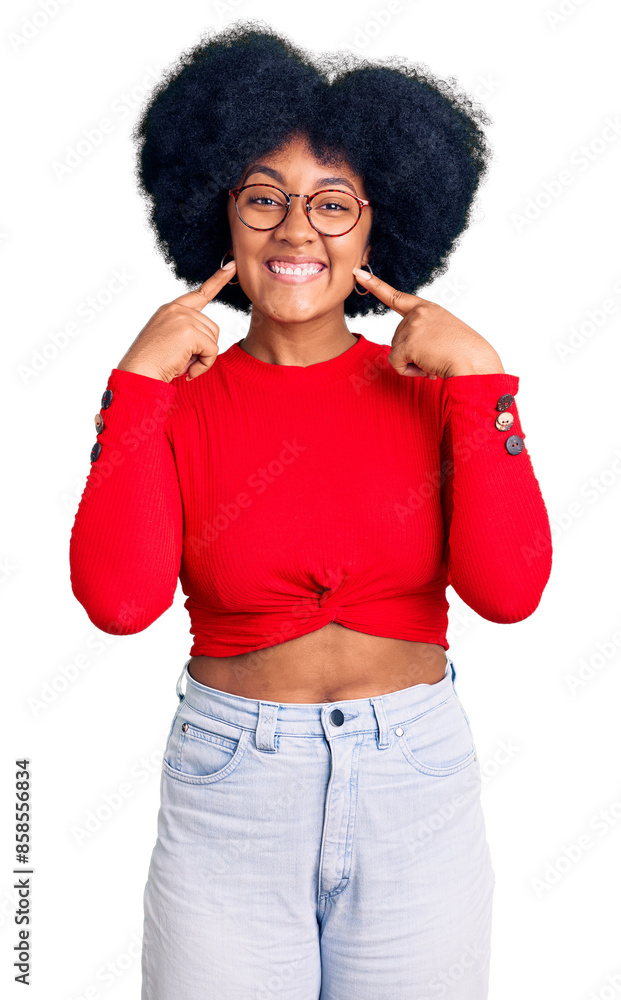 Wall mural young african american girl wearing casual clothes and glasses smiling with open mouth, fingers poin