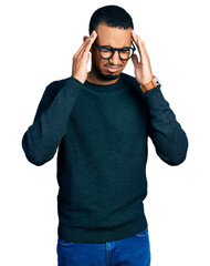 Young african american man wearing casual clothes and glasses with hand on head for pain in head because stress. suffering migraine.