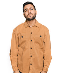 Obraz premium Young hispanic man wearing casual clothes relaxed with serious expression on face. simple and natural looking at the camera.