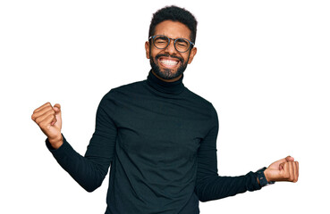 Young african american man wearing casual clothes very happy and excited doing winner gesture with arms raised, smiling and screaming for success. celebration concept.