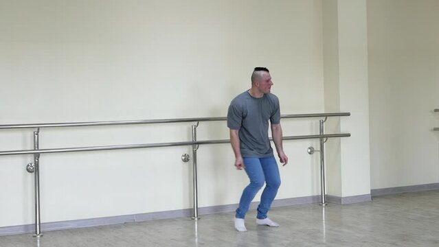 A man reprises a jazz or blues dance. Dance finger snaps. A guy teaches choreography in a dance hall