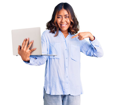 Young beautiful mixed race woman working using computer laptop pointing finger to one self smiling happy and proud