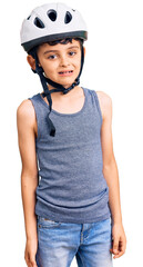 Little cute boy kid wearing bike helmet looking positive and happy standing and smiling with a confident smile showing teeth