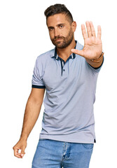 Handsome man with beard wearing casual clothes doing stop sing with palm of the hand. warning expression with negative and serious gesture on the face.