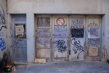 Lisboa, Portugal - 26.02.2024: The doors of an abandoned building, covered with graffiti and...