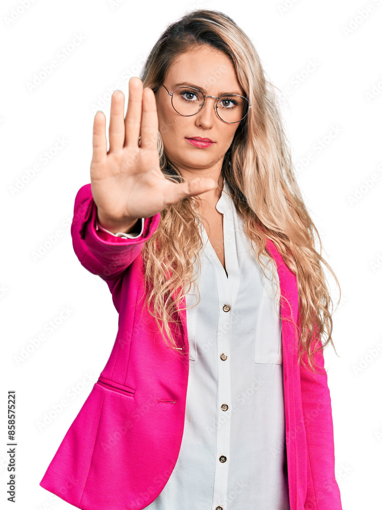 Sticker young blonde woman wearing business style and glasses doing stop sing with palm of the hand. warning