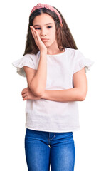 Fototapeta premium Cute hispanic child girl wearing casual white tshirt thinking looking tired and bored with depression problems with crossed arms.