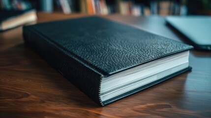 Black business book on desk Close up view