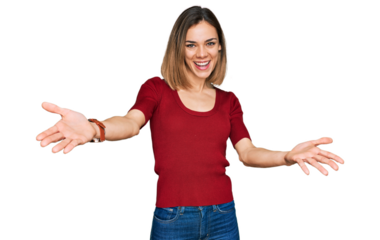 Young blonde girl wearing casual clothes looking at the camera smiling with open arms for hug. cheerful expression embracing happiness.