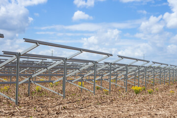 Prepared metal structure for solar panel installation, highlighting the setup of a solar farm.