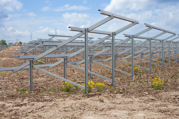 Prepared metal rack installation for mounting solar panels in an outdoor solar farm.