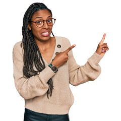 African american woman wearing casual clothes pointing aside worried and nervous with both hands,...