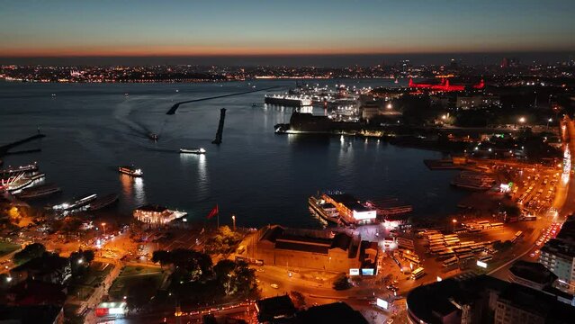 Sunset bird's eye view from aerial drone shooting of Kadikoy Port, Haydarpasa, harem and Bosphorus in the background, streets, people walking cars, Istanbul Kadikoy