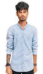 Fototapeta premium Young hispanic man wearing casual clothes looking at the camera blowing a kiss on air being lovely and sexy. love expression.