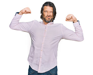 Middle age handsome man wearing business shirt showing arms muscles smiling proud. fitness concept.